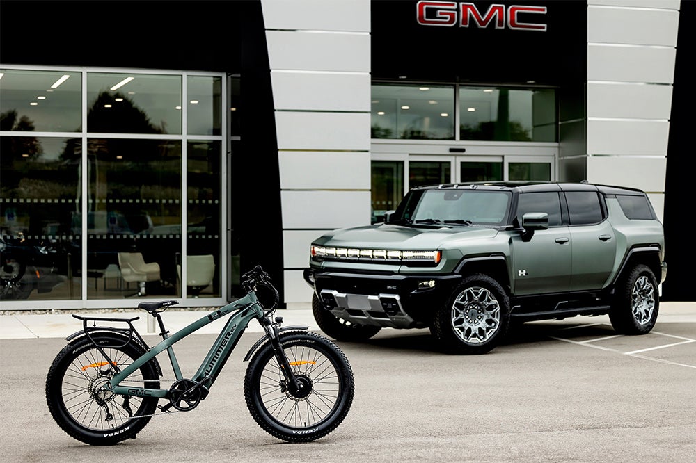 The AWD Electric Bike and Hummer EV are parked in front of the GMC dealership.