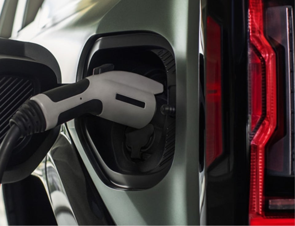 Close up of charging port with charger plugged in on a GMC Hummer EV SUV - Sheridan Motors GMC in Sheridan WY