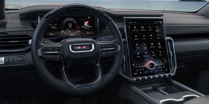 Close up image of the steering wheel of a 2024 GMC Acadia