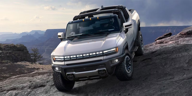 2024 GMC Hummer EV going downhill on a rock