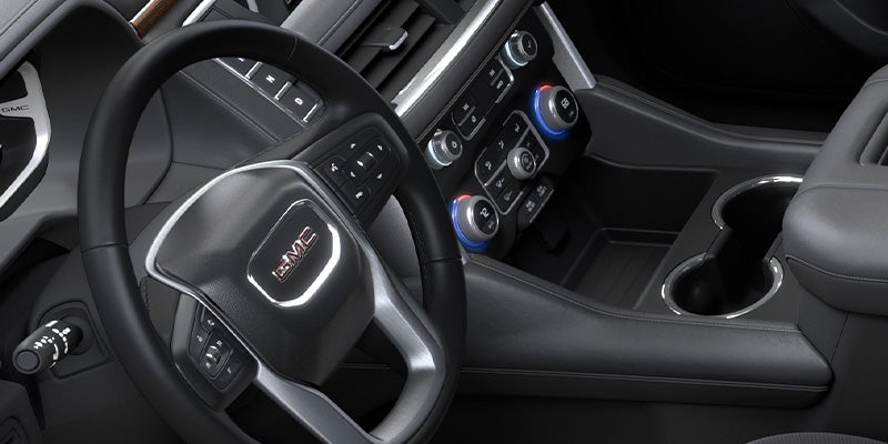 Close up image of the steering wheel and center console in a 2024 GMC Yukon XL