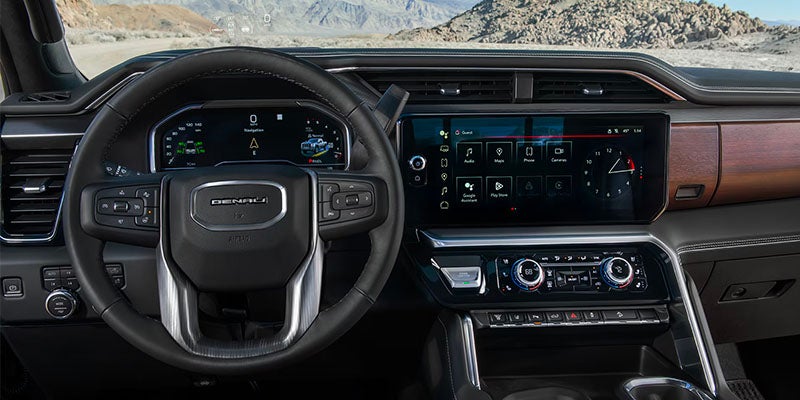 Interior image of a 2025 GMC Sierra 3500HD showcasing the steering wheel and dashboard